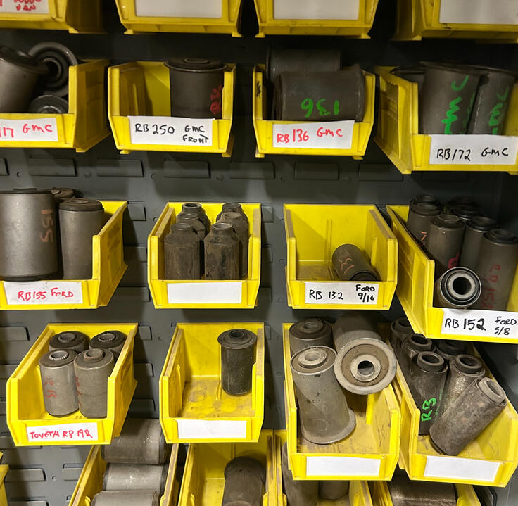 Spring Bushings, Centre Bolts & Suspension Hardware Leaf spring bushings, centre bolts, inserts, and suspension hardware organized in inventory bins at Standard Auto Spring Works.