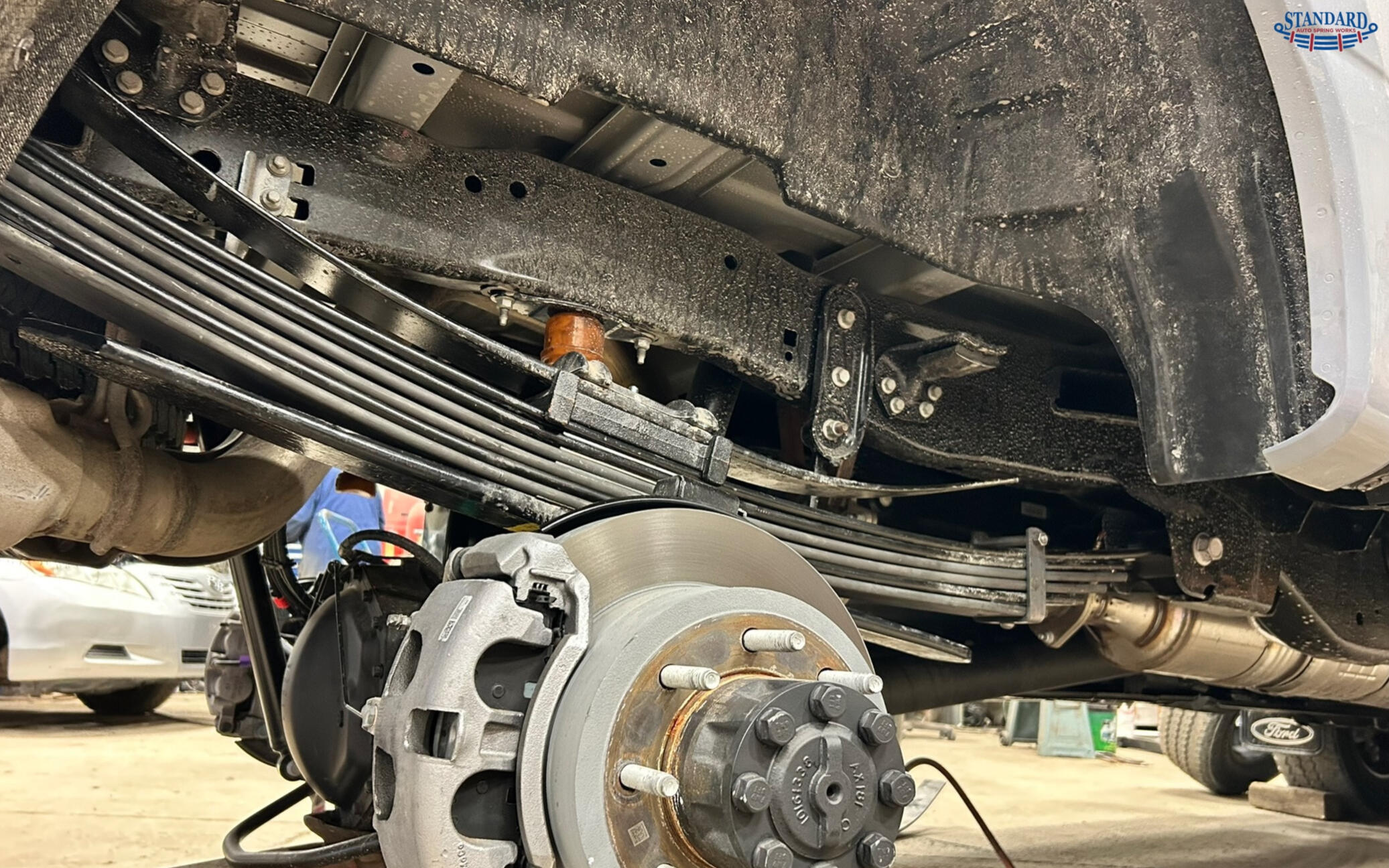 Leaf Spring Repair, Replacement & Custom Manufacturing | Standard Auto Spring Works Heavy duty leaf spring suspension system installed on a pickup truck, showcasing custom leaf spring repair, replacement, and suspension upgrades by Standard Auto Spring Works in Winnipeg, Manitoba.