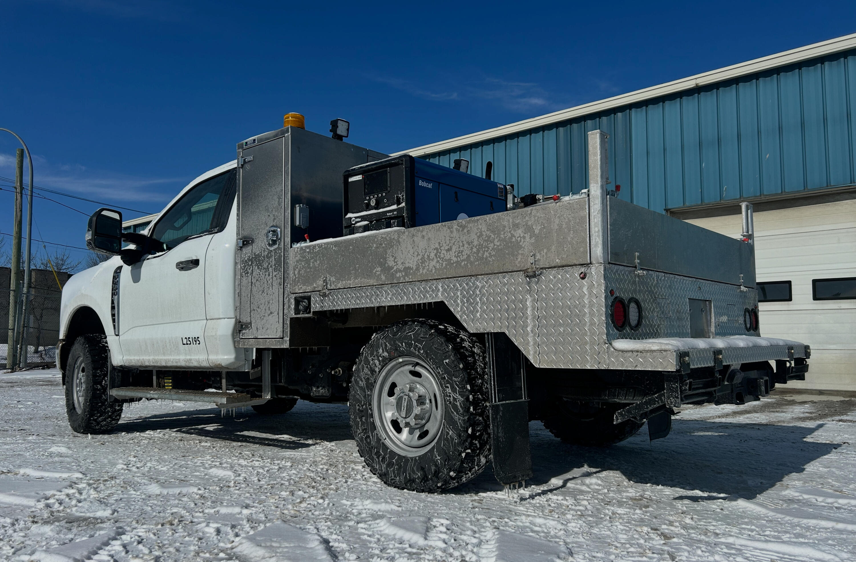 Welding & Fabrication Services | Standard Auto Spring Works Winnipeg Custom welding and fabrication work on a heavy-duty service truck at Standard Auto Spring Works in Winnipeg, including suspension modifications, brackets, spring hangers, mounts, and fleet equipment fabrication.