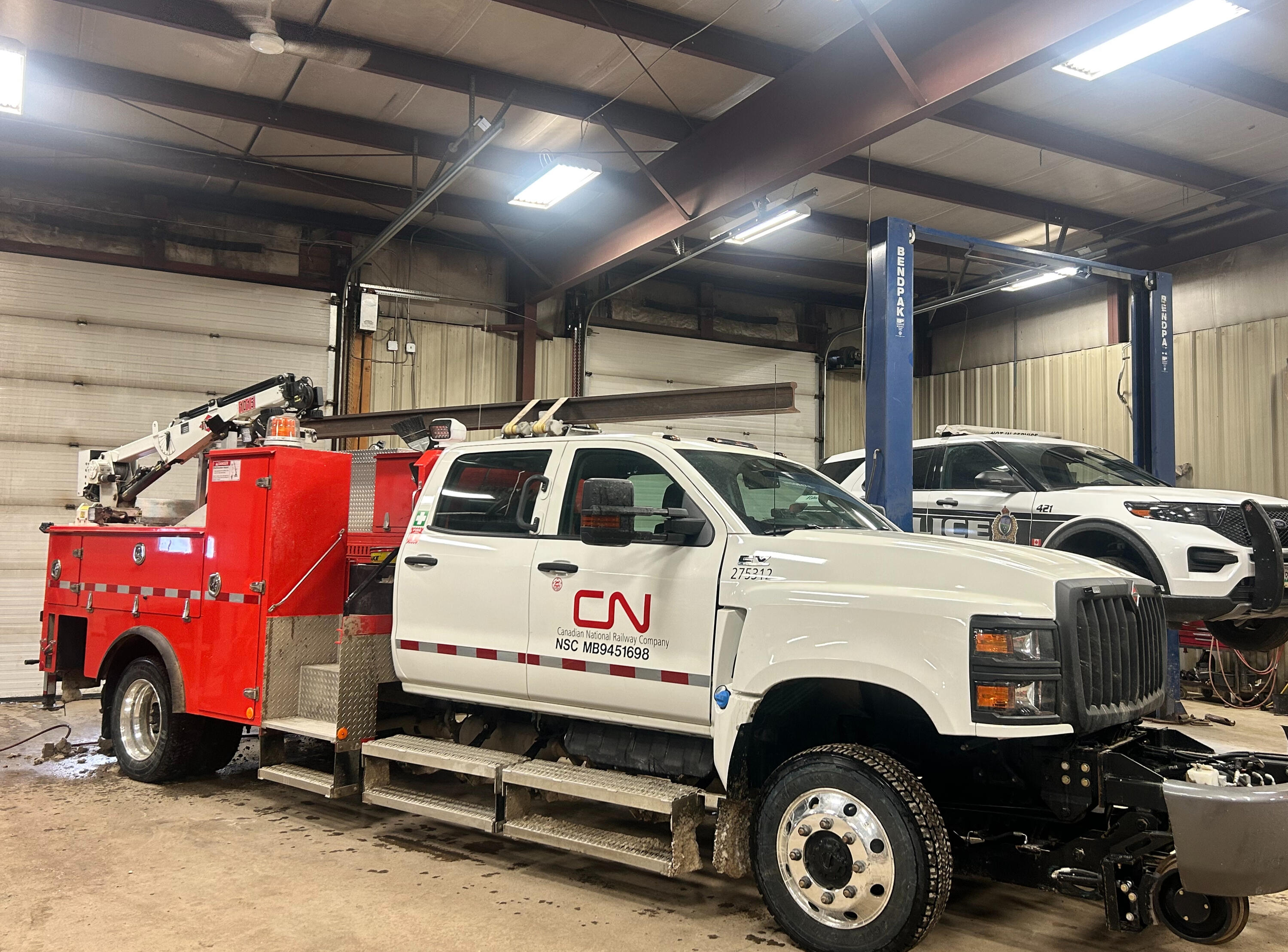 Heavy Duty Truck Suspension Upgrades | Standard Auto Spring Works Winnipeg Heavy-duty service truck receiving suspension upgrades at Standard Auto Spring Works in Winnipeg. HD leaf springs, add-a-leaf kits, lift kits, load support systems, and fleet suspension enhancements for commercial work trucks.